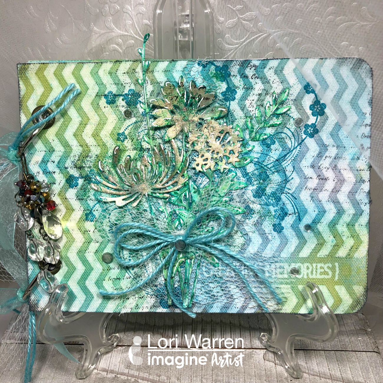 Handmade creative art journal featuring a mixed media cover in blues and greens.